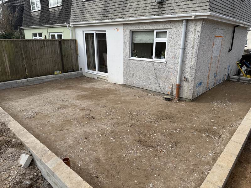 Extension groundworks at the rear of a house: blockwork brought up to ground level around a levelled area ready for the slab