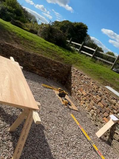 The finished dry stone retaining wall with a new gravelled area at its foot